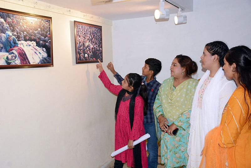 Visitor keenly viewing pictures exhibition after inaugurate in connection with Kashmir Black Day (Yaum Istehsal Kashmir) at Arts Council