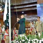 President Dr. Arif Alvi hoisting Pakistan's national flag at the official flag hoisting ceremony on the 77th Independence Day of Pakistan