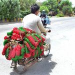 A motorcyclist on the way loaded with bangles delivery to bangle market