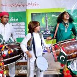 Musicians are performing a Dhol act (traditional drum) at Bab-e-Pakistan Foundation Walton Road on the occasion of 77th Independence Day celebration