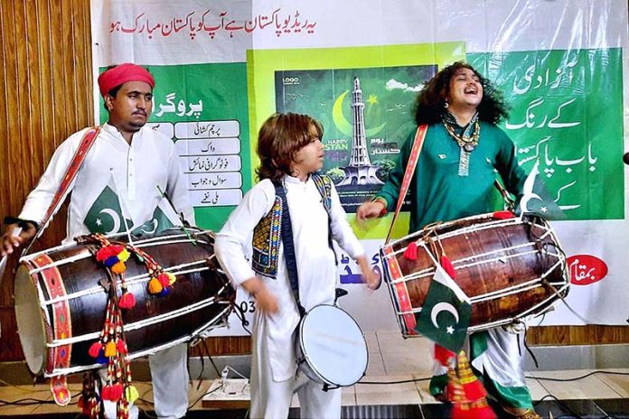 Musicians are performing a Dhol act (traditional drum) at Bab-e-Pakistan Foundation Walton Road on the occasion of 77th Independence Day celebration