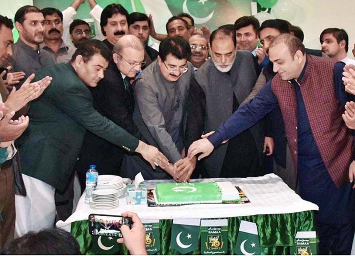 Chairman Senate, Muhammad Sadiq Sanjrani and Senators cutting a cake to Celebrate the Independence Day in Samaa News Bureau Office