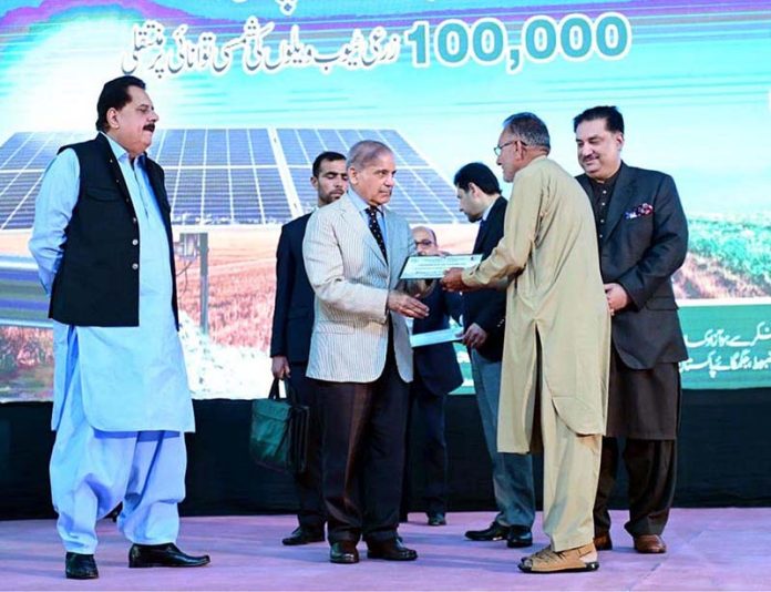 Prime Minister Muhammad Shehbaz Sharif giving certificates to farmers during the launching ceremony of National Program for the Solarization of Agricultural Tubewells