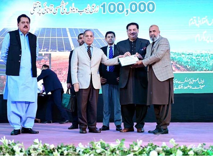 Prime Minister Muhammad Shehbaz Sharif giving certificates to farmers during the launching ceremony of National Program for the Solarization of Agricultural Tubewells