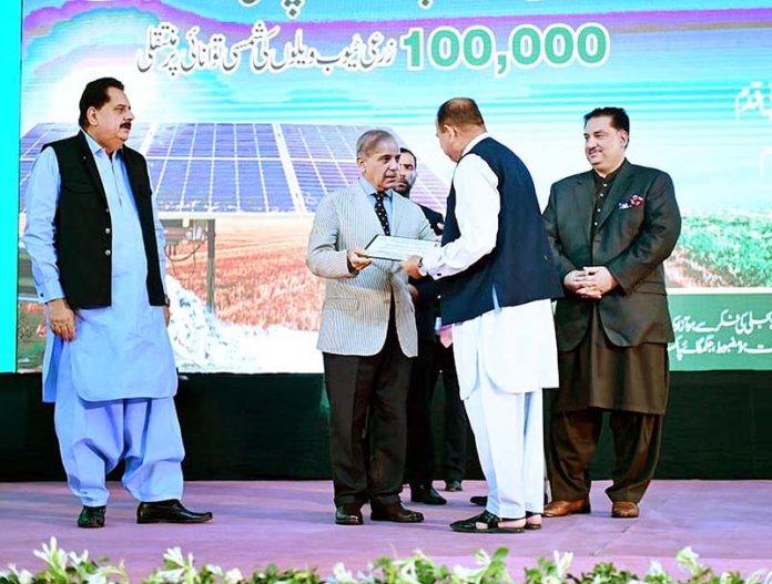 Prime Minister Muhammad Shehbaz Sharif giving certificates to farmers during the launching ceremony of National Program for the Solarization of Agricultural Tubewells