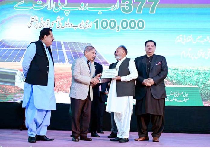 Prime Minister Muhammad Shehbaz Sharif giving certificates to farmers during the launching ceremony of National Program for the Solarization of Agricultural Tubewells