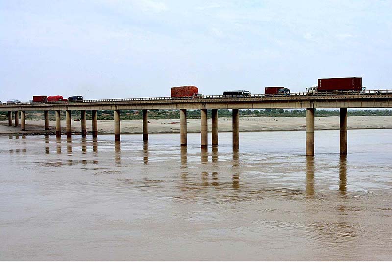 A view of heavy vehicles passing through on the Mehran Bridge over the River Indus at bypass