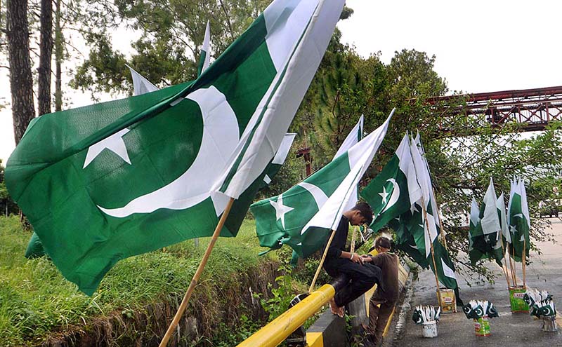 Vendors displaying National flags along Islamabad Expressway to attract the customers as the nation starts preparations to celebrate Independence Day in befitting manners