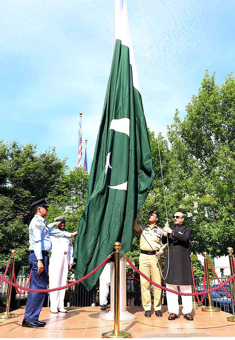 Ambassador of Pakistan to the United States, Masood Khan unfurling the National Flag on the occasion of Independence Day of Pakistan at Embassy of Pakistan