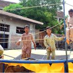 Children enjoy jumping on the trampoline at Latifabad