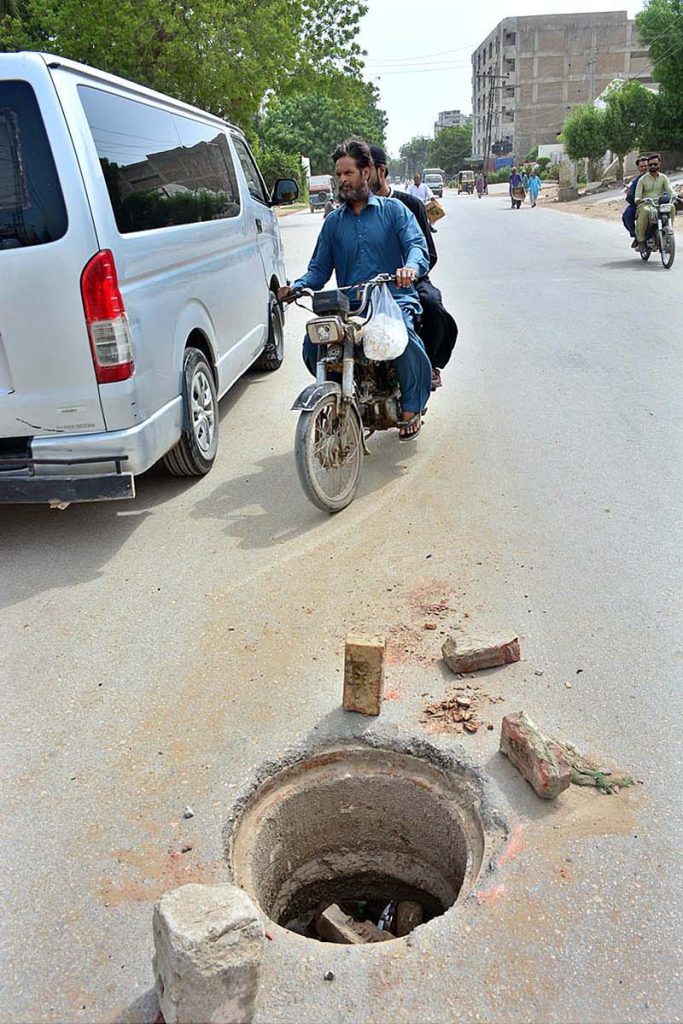 A view of open sewerage manhole on the road at Bhitai Hospital Road may cause any mishap and needs the attention of concerned authorities