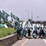 Commuters take break to purchase national flag as the nation celebrates the Independence Day with evangelism across the country