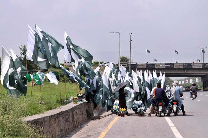 Commuters take break to purchase national flag as the nation celebrates the Independence Day with evangelism across the country