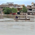 Fishermen on boat catching fish at Phuleli Canal