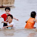 Children are enjoying in the Indus River during overcast weather