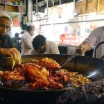 Vendors frying chickens for customers at Qissa Khawani Bazaar