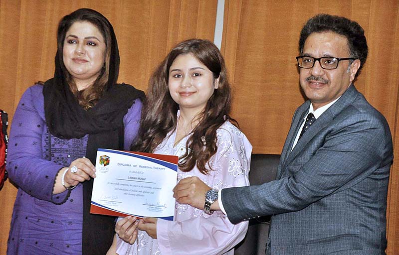 Parliamentary Secretary for Education, Professional Training Ms. Zeb Jaffar distributing certificate to appreciate the team's endeavor focused on producing printed Materials for children with dyslexia at National Book Foundation
