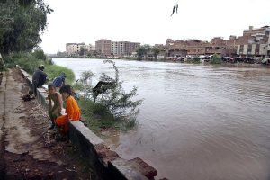 Fishermen on boat catching fish at Phuleli Canal