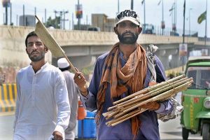 A vendor selling hand fans while shuttling on the road