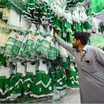 Customer selecting and purchasing dress with national flag color for his daughter in connection with upcoming Independence Day celebration