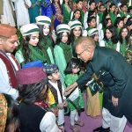 President Dr. Arif Alvi shaking hands and exchanging Independence Day greetings with children at the official flag hoisting ceremony on the 77th Independence Day of Pakistan