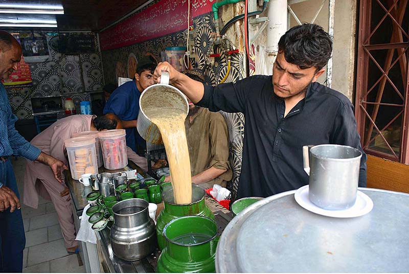 Vendor is preparing tea for his customers at his workplace