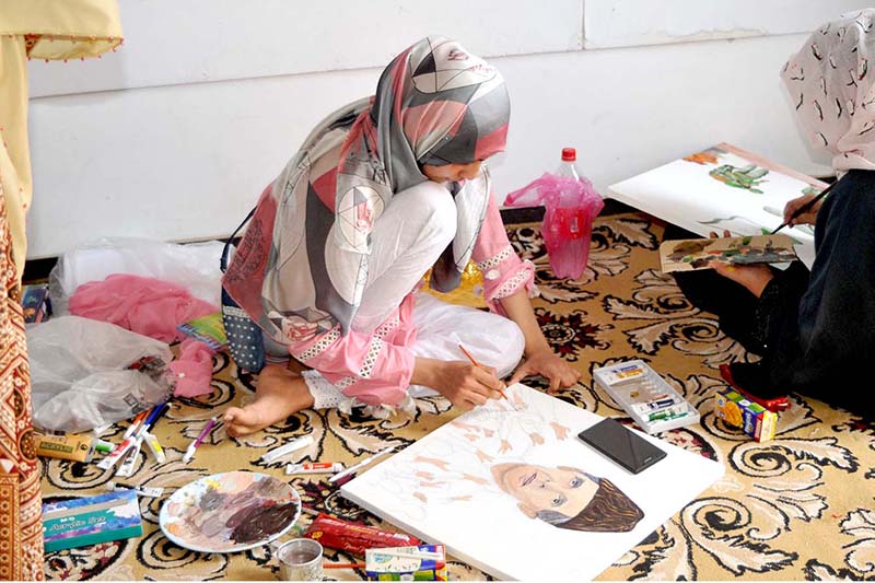 Students participating in a painting competition in connection with independence day celebrations organized by the Punjab Council of Arts Multan division at the Arts Gallery