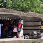 A vendor displaying School bags in a shelter of bus stop to attract the customers near Aabpara Chowk