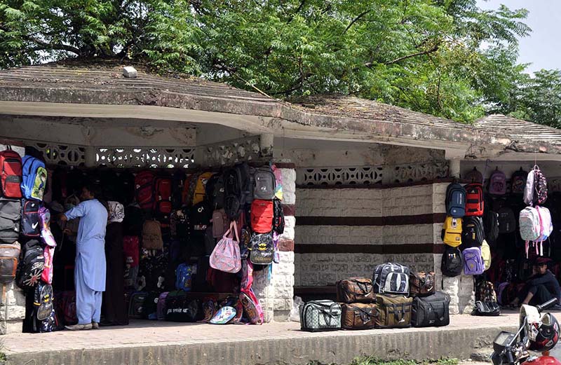 A vendor displaying School bags in a shelter of bus stop to attract the customers near Aabpara Chowk