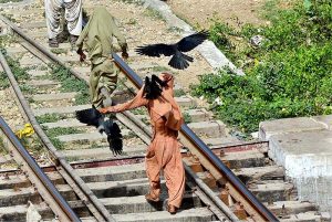 People passing water canal through railway bridge at Tando Yousuf area