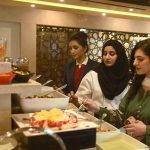 Women taking food items at food festival in a local hotel