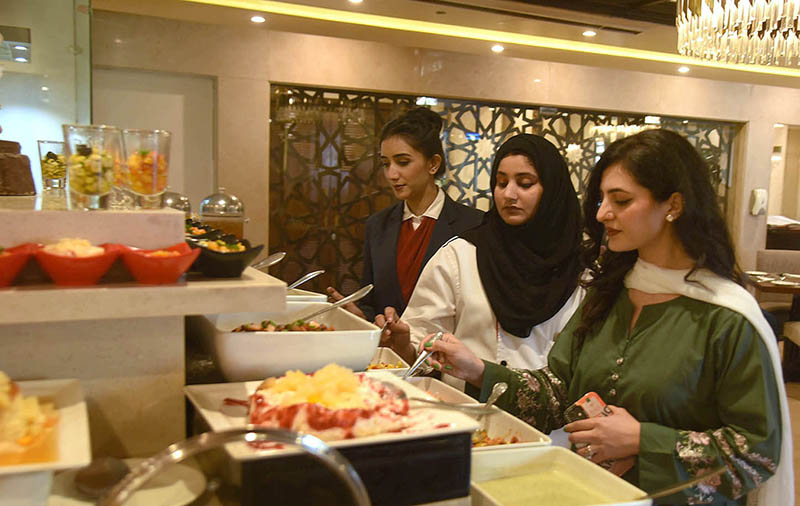 Women taking food items at food festival in a local hotel