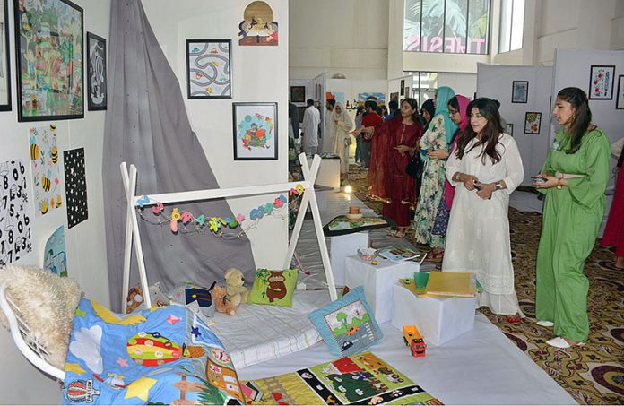 Students visiting stalls during 13th Thesis Display of School of Arts and Designing at National Textile University (NTU)