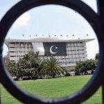 The National flag of Pakistan on the WAPDA House building in celebration of August 14 Pakistan Day in the Provincial Capital