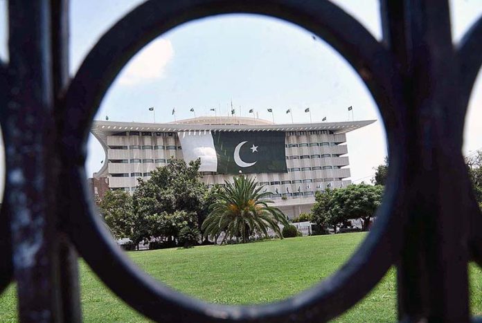 The National flag of Pakistan on the WAPDA House building in celebration of August 14 Pakistan Day in the Provincial Capital