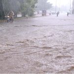 Vehicles passing through rainwater during heavy rain in the city
