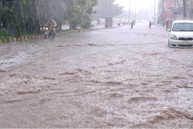 Vehicles passing through rainwater during heavy rain in the city