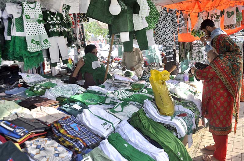 A large number of women and children select national flag and other stuffs displayed along the roadside as the nation start to celebrate the Independence Day with evangelism across the country