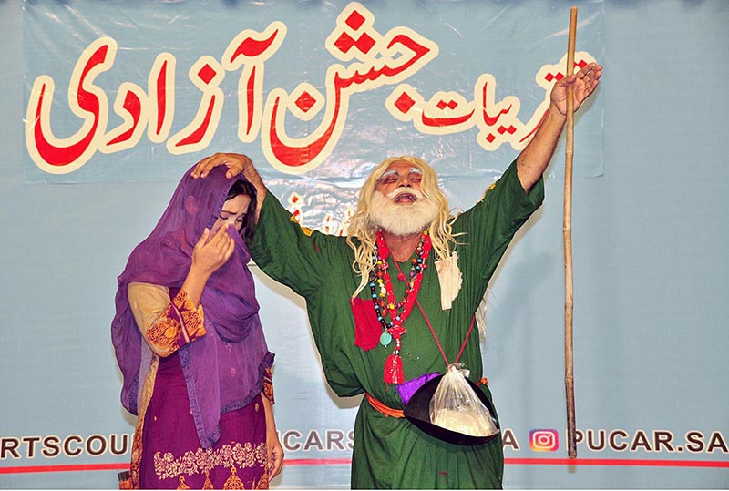 Artists performing on stage during drama titled (tota Jannat da) in connection with Independence Day organized by Sargodha Arts Council