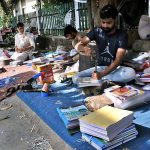 Bookbinders busy in binding a books near Abpara Market in the Federal Capital