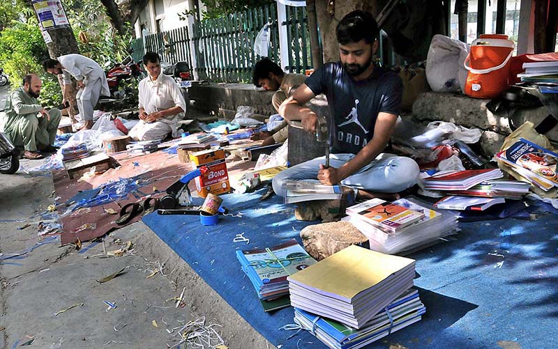 Bookbinders busy in binding a books near Abpara Market in the Federal Capital