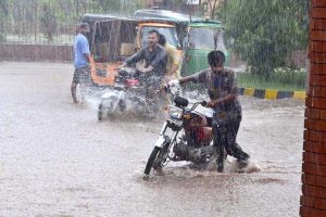 Vehicles passing through rainwater during heavy rain in the city