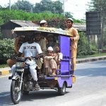 On returning from school, children are traveling dangerously on the motorcycle rickshaw at Jalo Mor main road.