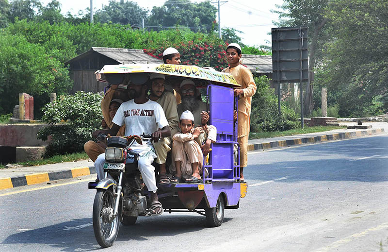 On returning from school, children are traveling dangerously on the motorcycle rickshaw at Jalo Mor main road.