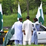 Commuters take break to purchase national flag as the nation celebrates the Independence Day with evangelism across the country