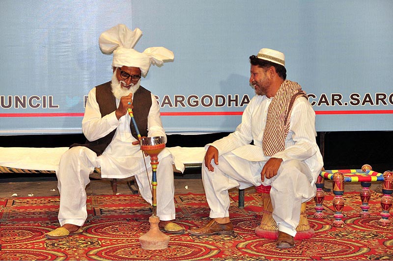 Artists performing on stage during drama titled (tota Jannat da) in connection with Independence Day organized by Sargodha Arts Council