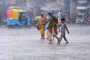 Vehicles passing through rainwater during heavy rain in the city