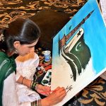 Student giving Final touches to her painting during Independence Day Painting Competition