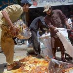 Laborers filling sacks of Gum Rosin at Qissa Khawani Bazar