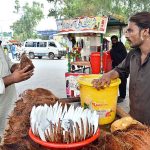 A vendor selling coconut at Kalma Chowk to earn for livelihood
